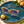 Load image into Gallery viewer, Lunettes Nèfle posées sur une céramique bleu pétrole près de fruits nèfles

